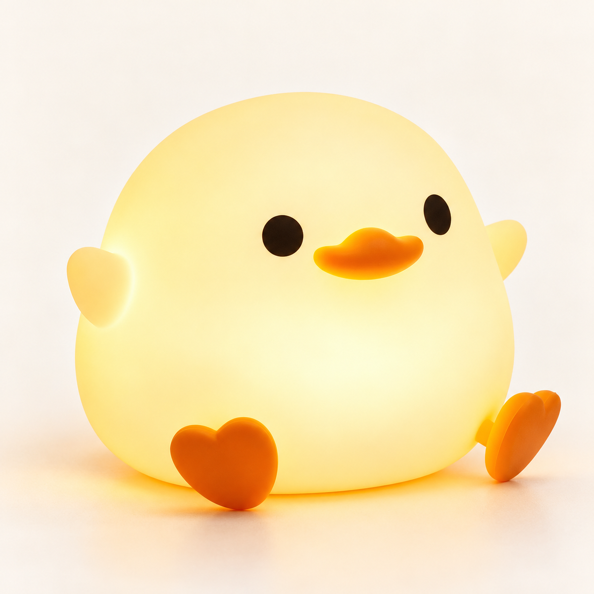 Veilleuse canard en silicone allumée, lumière douce, sur fond clair